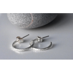 Chequer Textured Eco Silver Hoop Earrings, pictured with butterfy backs, one overlapping the other slightly, pictured at an angle. 