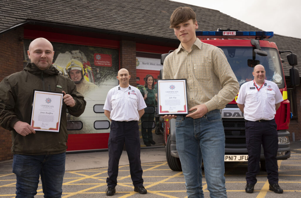 Presentation to James Readfern and Jake Kay in front of Darwen Fire Station and fire engine with Group Manager Wilson and Station Manager Harvey