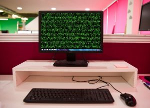 Hacker Running Code Down Computer